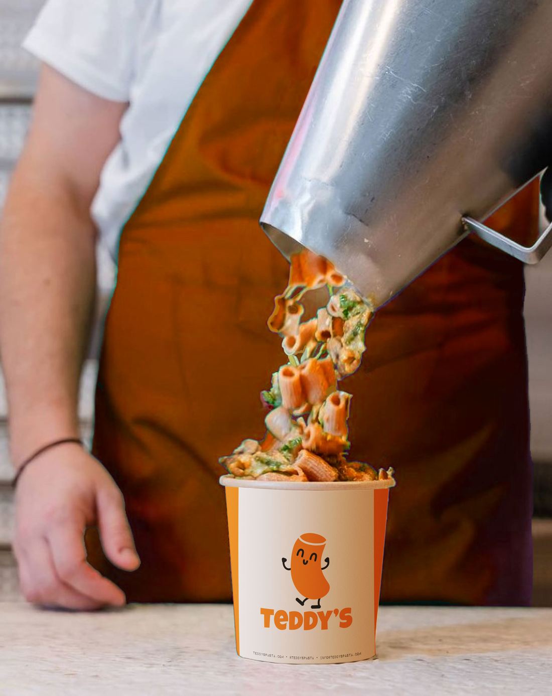 Fresh pasta being poured from a steel pot into a Teddy's cup with the mascot on it